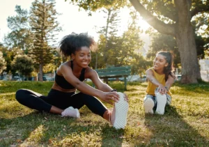 Two womens stretching in the grass